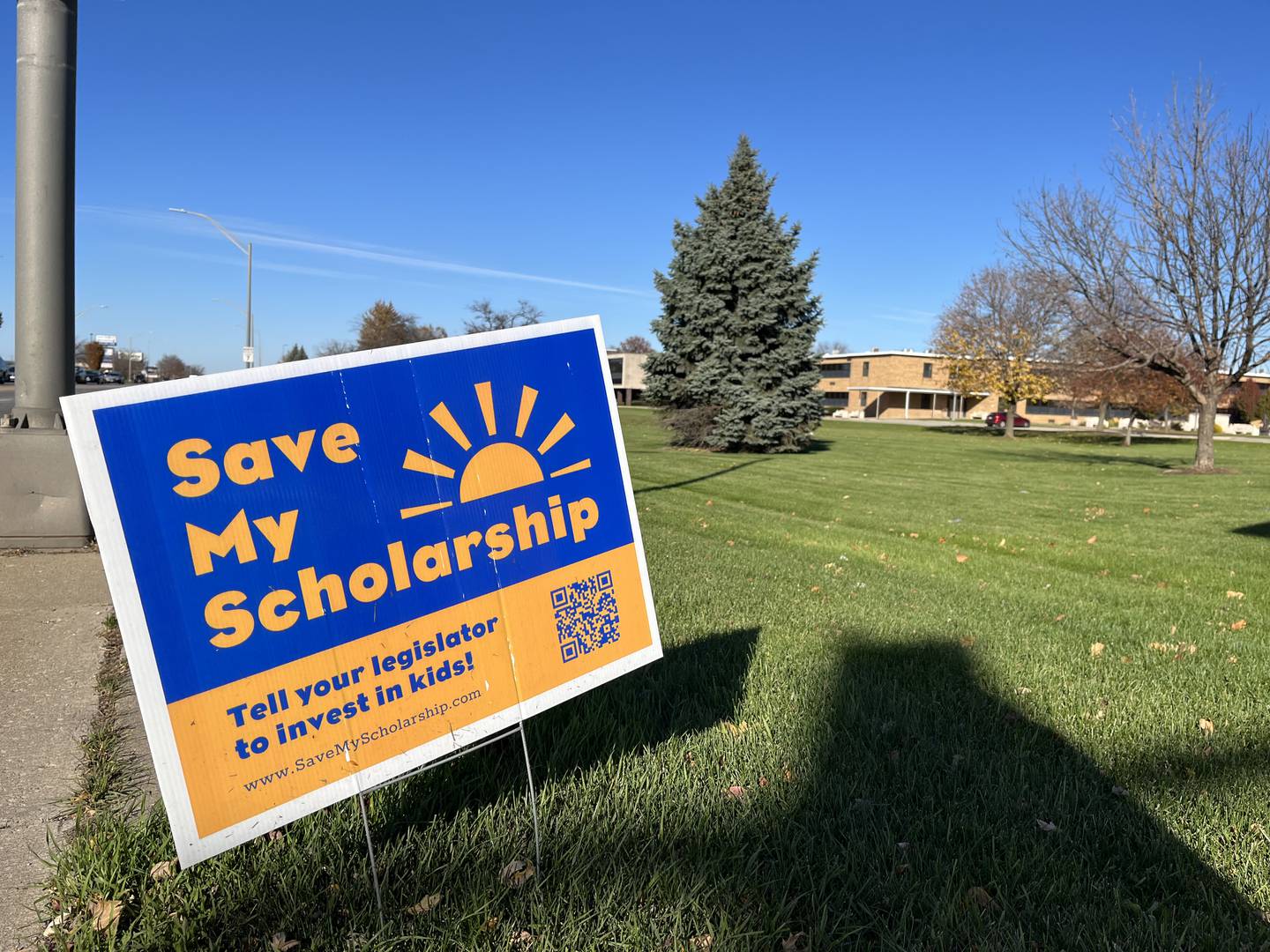 A sign outside Joliet Catholic Academy supporting the extension of the Invest In Kids Act tax credit scholarship program, seen on Thursday, Nov. 9, in Joliet.