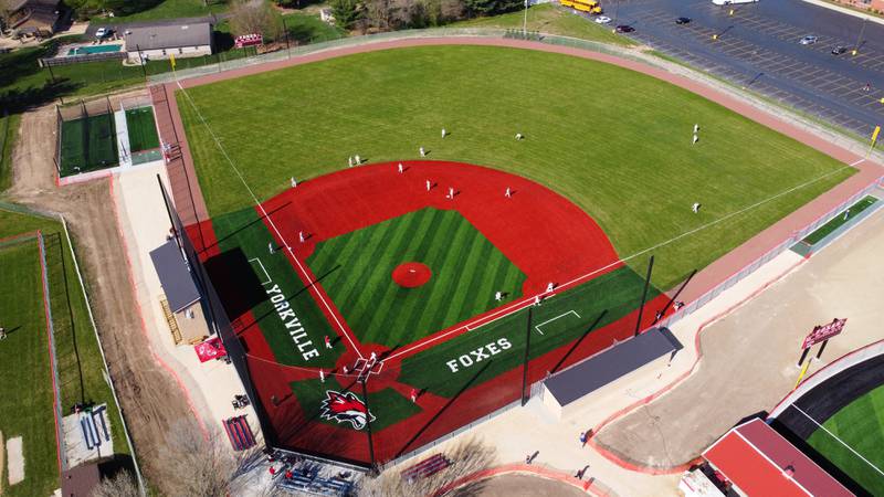 Yorkville baseball players warm up on their new turf baseball field prior to the start of their game against West Aurora at Yorkville High School on Monday, April 15, 2024.