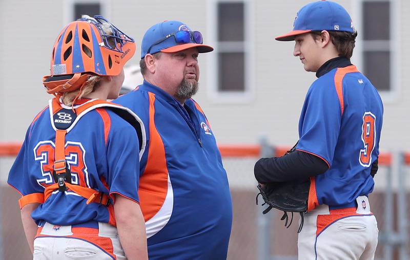 Genoa-Kingston head coach Roger Butler visits the mound with catcher Tristan Swenson to talk to pitcher Brycen Lavender during their game against Winnebago Tuesday, April 12, 2022, at Genoa-Kingston High School.