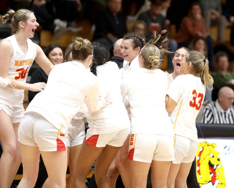 Batavia’s Brooke Carlson (center) celebrates breaking the school’s all-time points scored during a game against St. Charles East at Batavia on Thursday, Feb. 1, 2024.