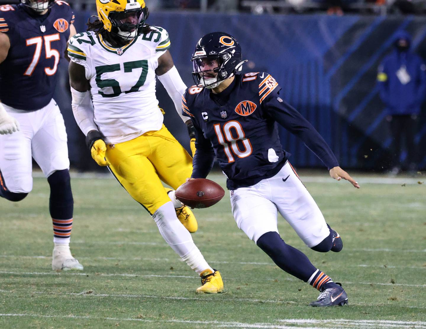 Chicago Bears quarterback Caleb Williams scrambles away from Green Bay Packers defensive end Brenton Cox Jr. for a big gain Saturday, December 20, 2025, during their game at Soldier Field in Chicago.