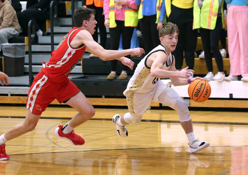 Sycamore's Xander Lewis drives by La Salle-Peru's Nick Olivero during their game Tuesday, Feb. 4, 2025, at Sycamore High School.
