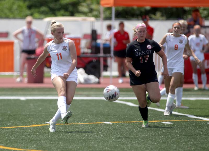 Crystal Lake Central’s Madeline Gray (left) kicks the ball away from Benet’s Rachel Burns during a Class 2A girls state soccer semifinal at North Central College in Naperville on Friday, June 2, 2023.