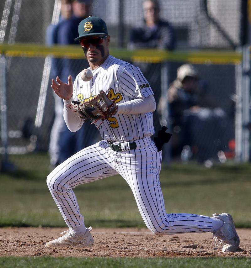 Crystal Lake South\s Yandel Ramirez juggles the ball as he fields the baseball during a Fox Valley Conference baseball game against Prairie Ridge on Monday, April 8, 2024, at Crystal Lake South High School.