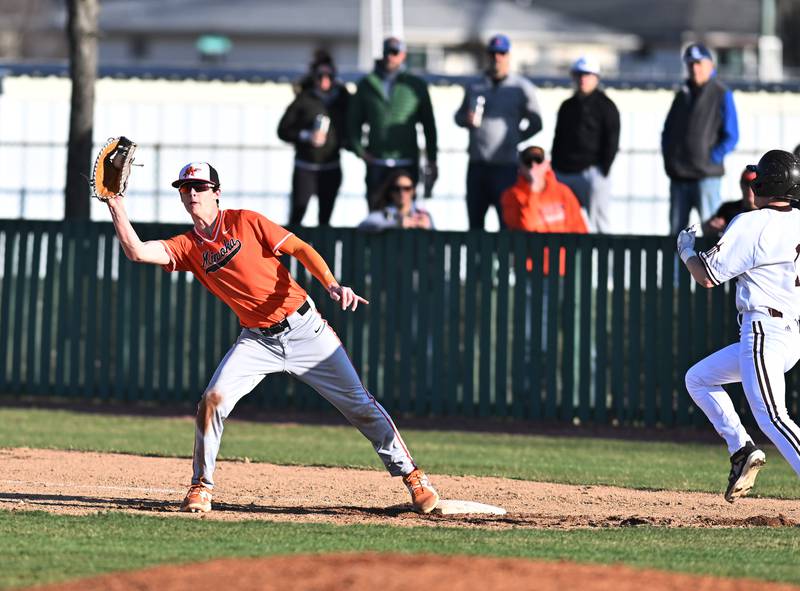 Minooka's Noah Munson tags the runner out on first base during the non-conference game Joliet Catholic on Monday, March. 11, 2024, at Joliet.