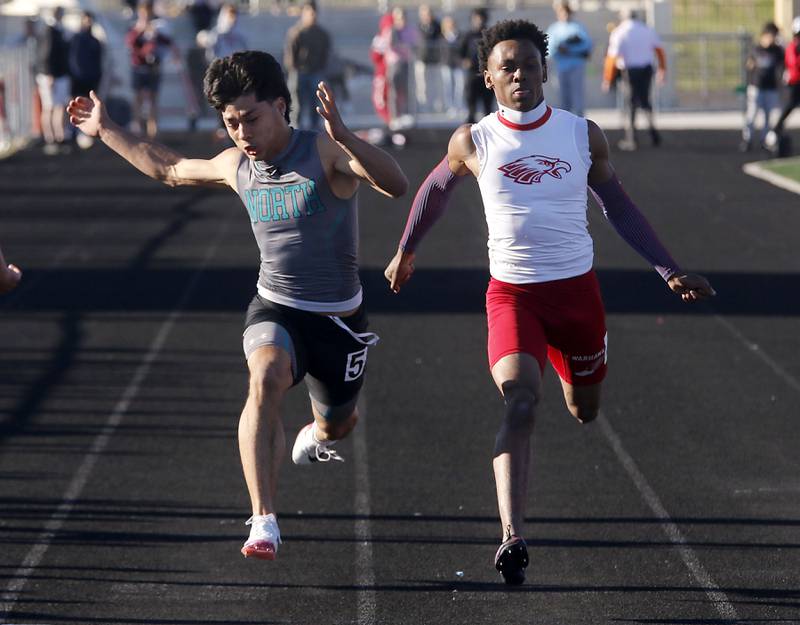 Woodstock North's Adan Castaneda wins the 100 meter dash over North Chicago’s Marlin Jeffries Jr. during the IHSA Class 2A Richmond-Burton Sectional Boys Track and Field Meet on Wednesday, May 20, 2026, at Richmond-Burton High School.