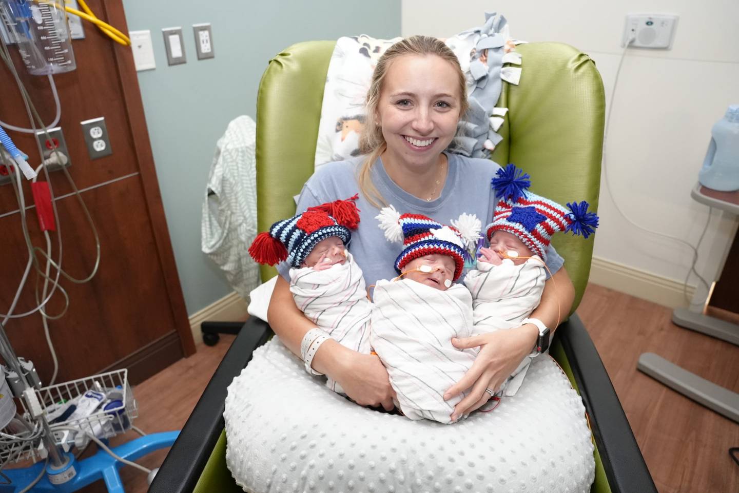 Samantha LeSage of Manteno holds her triplet sons Miles, Lane and Elijah at Silver Cross Hospital in New Lenox. The three newest LeSages celebrated the Fourth of July in style, courtesy of St. Mary Immaculate Church of Plainfield and Holy Family Church in Shorewood, whose parishioners delivered crocheted holiday hats to the woman and infant services department at Silver Cross.