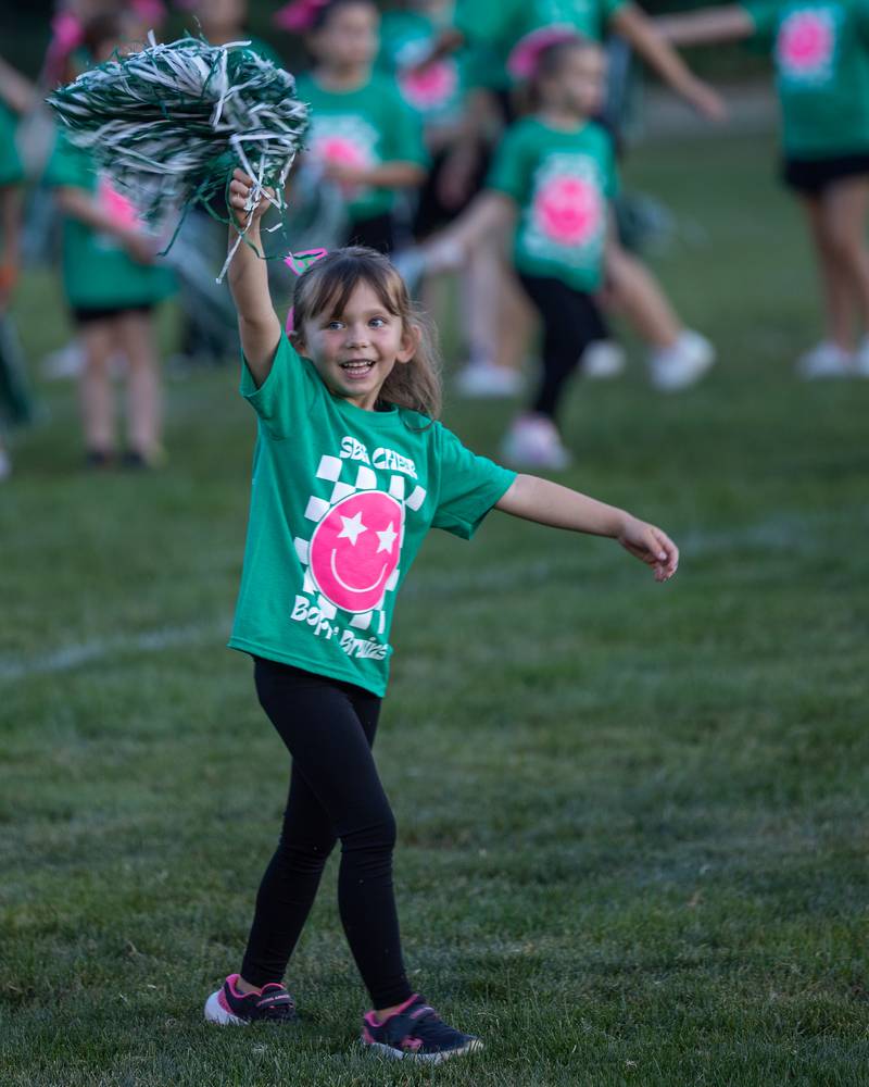 Emma Mcmillin of Boppin' Bruins, waves to family before performance on Friday, Sept 12, 2025 at Captain Thomas J. Heitmann field in Peru.