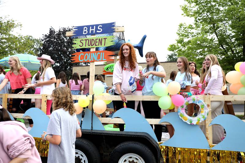 Batavia High School Student Council members ride on a float during the school’s annual homecoming parade on Wilson Street on Wednesday, Sept. 20, 2023.
