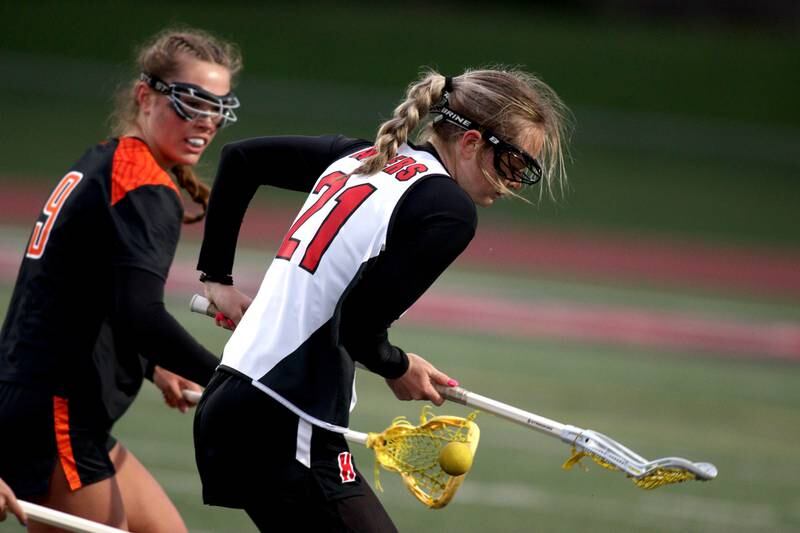 Huntley’s Sophie Zion, right, battles Crystal Lake Central’s Fiona Lemke in varsity lacrosse at Huntley Wednesday.