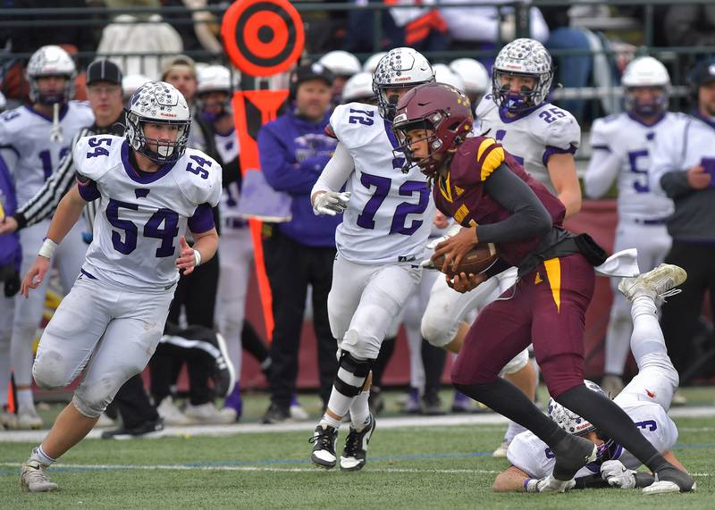 Montini quarterback Israel Abrams scrambles for a first down against Wilmington during a Class 3A semifinal game on November 23, 2024 at Montini Catholic High School in Lombard.