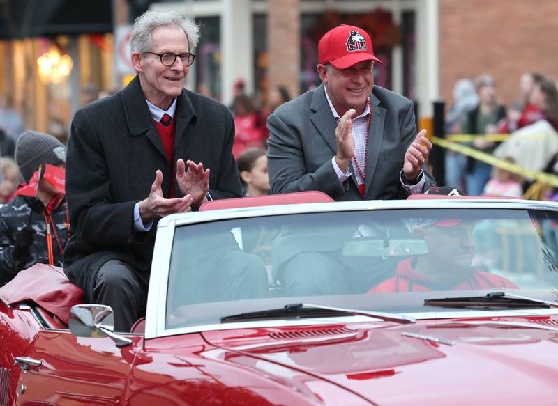 DeKalb City Manager Bill Nicklas (left) and Mayor Cohen Barnes ride in the March of the Huskies parade during the NIU Huskie Homecoming Block Party Thursday, Oct. 12, 2023, in downtown DeKalb.