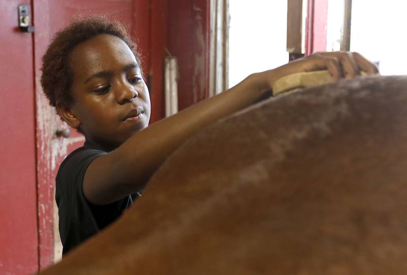 Richard Taylor-Terry, 11, brushes Hunter as he helps prepare the retired Medieval Times horse for a riding lesson Friday July, 8, 2022, at the R Double J Ranch, 2800 Derby Lane, in McHenry. The R Double J Ranch recently got the contract to operate this equine facility from McHenry with the goal of making it more of a community-centric center and make learning about horses and riding open to all.