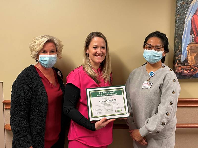 (Left to right) Heather Bomstad, chief nursing officer, hands off the DAISY Award to Shannon Sibert, along with Annabel Tomas, director of the Family Birthing Center at OSF St. Elizabeth Medical Center in Ottawa.