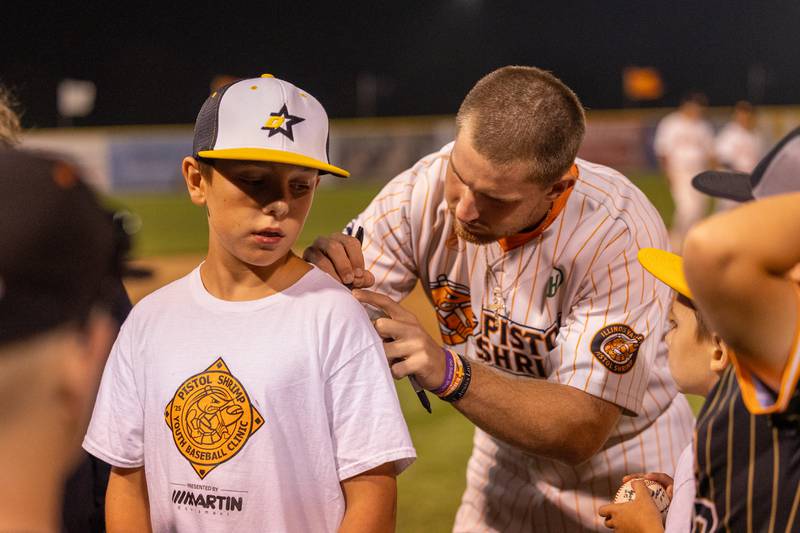 Kane Stevenson gets a shirt signed by Tyler Dorsch of the Pistol Shrimp after the final game of the season on Thursday, July 31, 2025, at Schweickert Stadium in Peru.