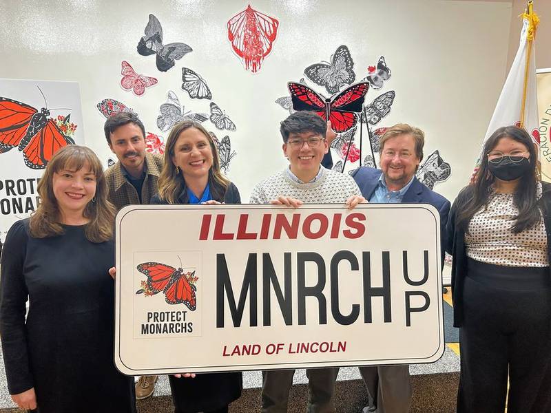 Illinois Environmental Council Executive Director Jen Walling, center, helps unveil the new specialty monarch butterfly license plate Nov. 16, 2023, alongside fellow environmentalists from IEC, the Natural Resources Defense Council and Sierra Club Illinois.