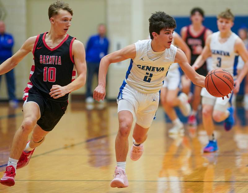 Geneva’s Gabe Jensen (2) brings the ball up the court against Batavia’s Nate Nazos (10) during a basketball game at Geneva High School on Friday, Dec 15, 2023.