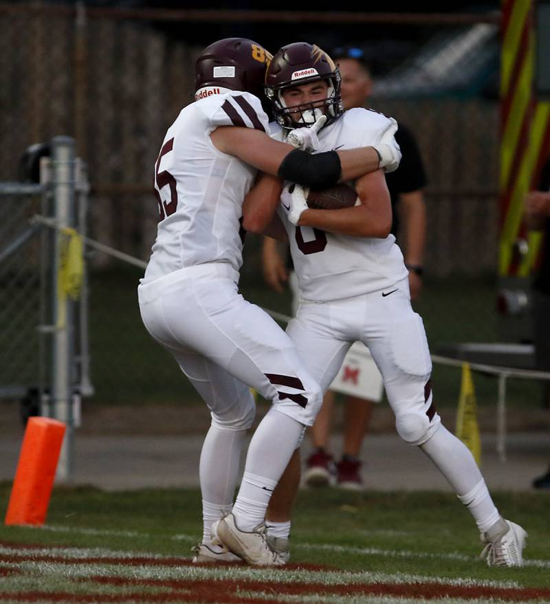 Richmond-Burton's Luke Bresnahan hugs his terammate, Jack Martens, after Martens ran for a touchdown during a nonconference football game against Marian Central Friday, Aug. 25, 2023, at Marian Central Catholic High School.