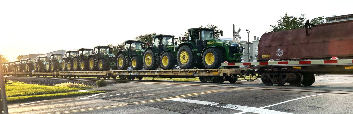 New John Deere tractors head through Morrison as they are transported on the Union Pacific Railroad on Saturday, June 21.