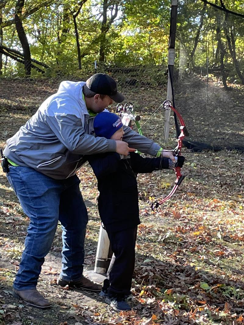 Nathan Sward learns how to shoot an arrow during archery instruction at Echo Bluffs.