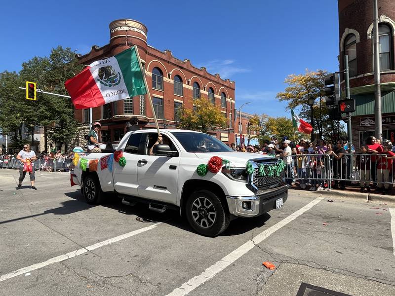 A truck with the national flag of Mexico traveling down Chicago Street for the 60th annual Mexican Independence Day parade on Saturday, Sept. 23, 2023, in downtown Joliet.