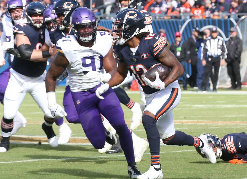 Chicago Bears wide receiver Velus Jones Jr. runs the ball down the field as Minnesota Vikings offensive lineman Pat Jones II looks to make the tackle on Sunday, Oct. 15, 2023 at Soldier Field.