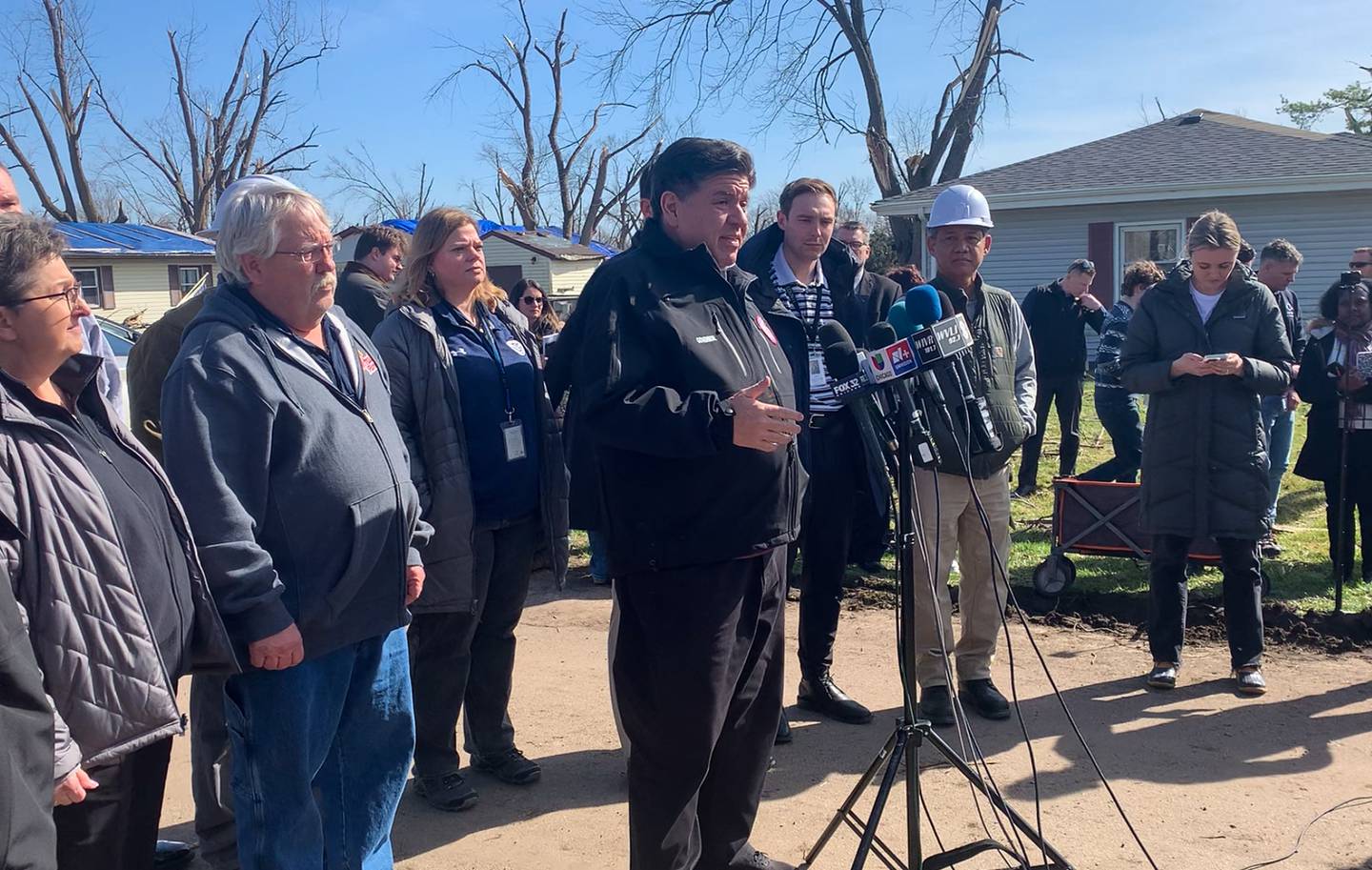 Gov. JB Pritzker speaks to a crowd on Strasma East Drive on Thursday, March 12, 2026, following a tour of the damage in Aroma Park from the March 10 EF-3 tornado.