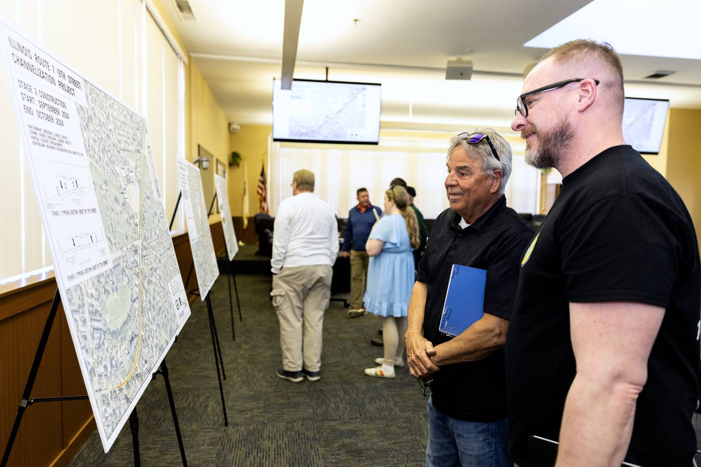 (L:R) Michael Harvey and Michael Matuszak, with Lockport-based business Portable John, look at the Illinois Route 7 Channelization Project plans during the pre-construction open house at Lockport City Hall on April 15, 2024.