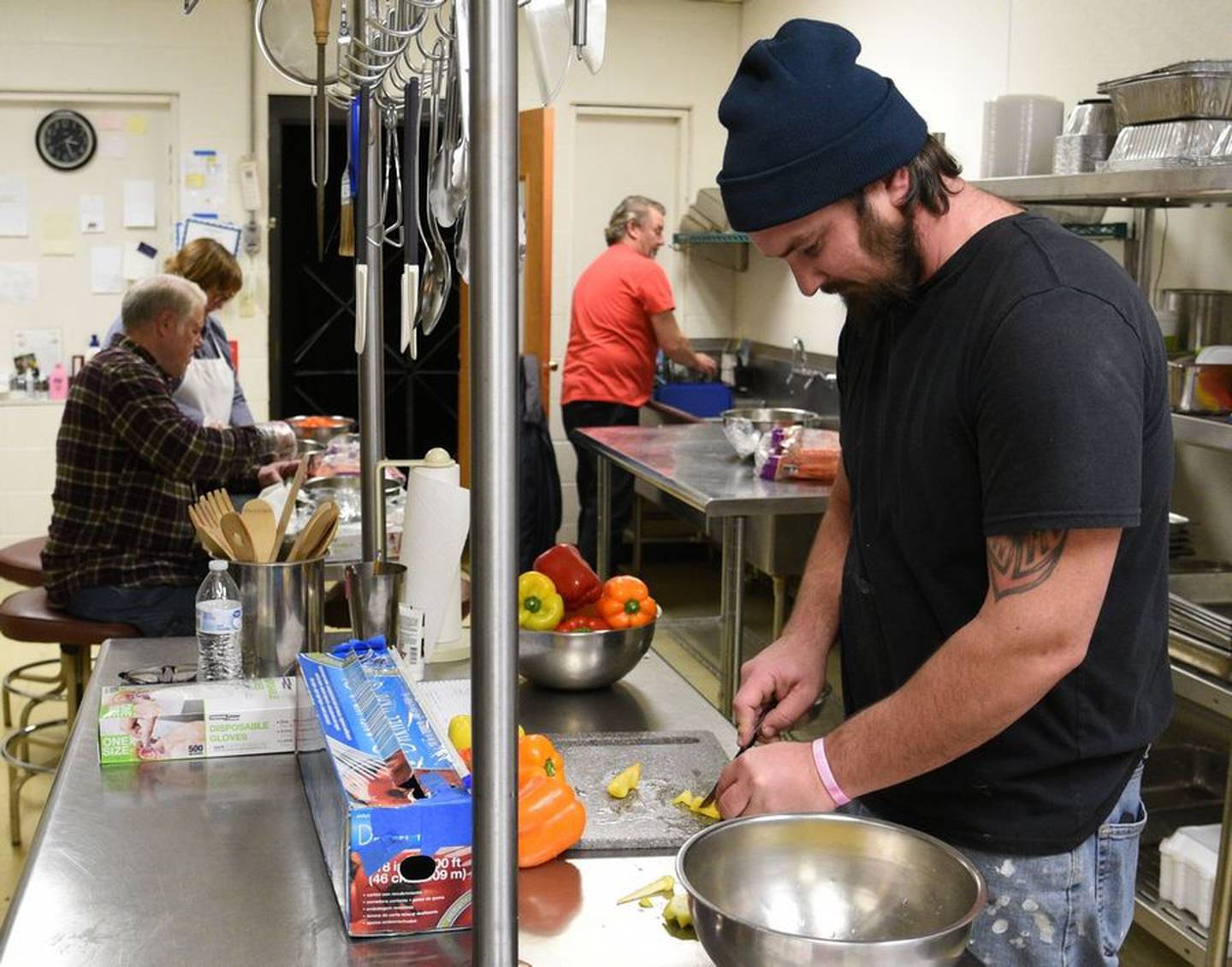 Nick Spoerl of Wasco dices peppers for salads that will be part of the Thanksgiving meals served to inmates in the recovery pod at the Kane County jail.