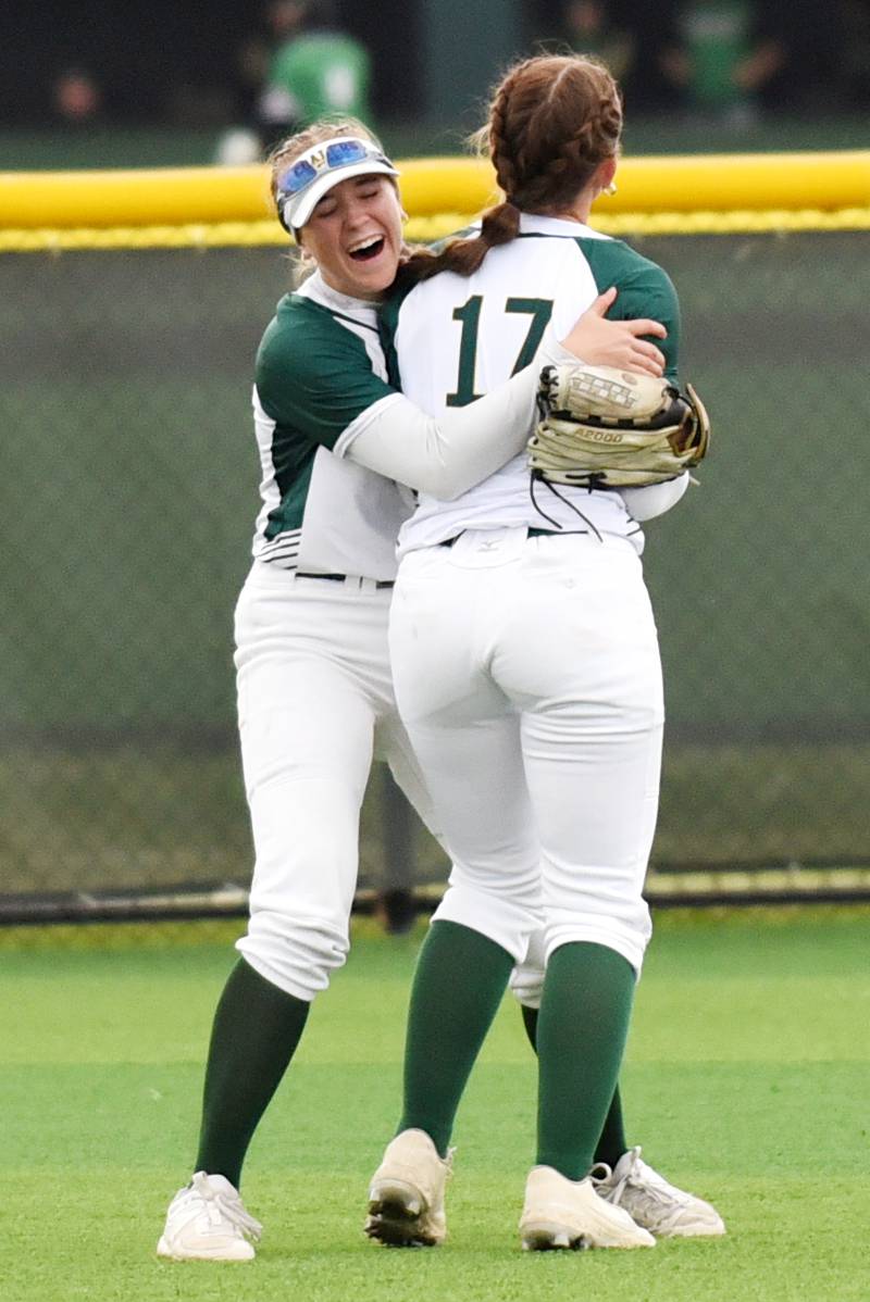 Coal City's Madi Petersen, left, hugs Mackenzie Croxton after Croxton's catch in center field during the Class 2A Coal City Regional semifinals against Joliet Catholic Wednesday, May 21, 2025.