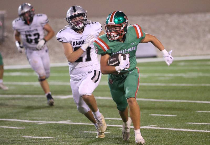 L-P's Rylynd Rynkewicz sprints down the field as Kaneland's Jackson Little chases after him on Friday, Oct. 17, 2025 at Howard Fellows Stadium.