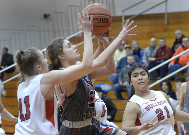 Flanagan-Cornell/Woodland’s Raegan Montello gets a shot away despite the block attempt by Streator’s Cailey Gwaltney in the 1st period on Tuesday, Jan. 24, 2023 at Streator High School.