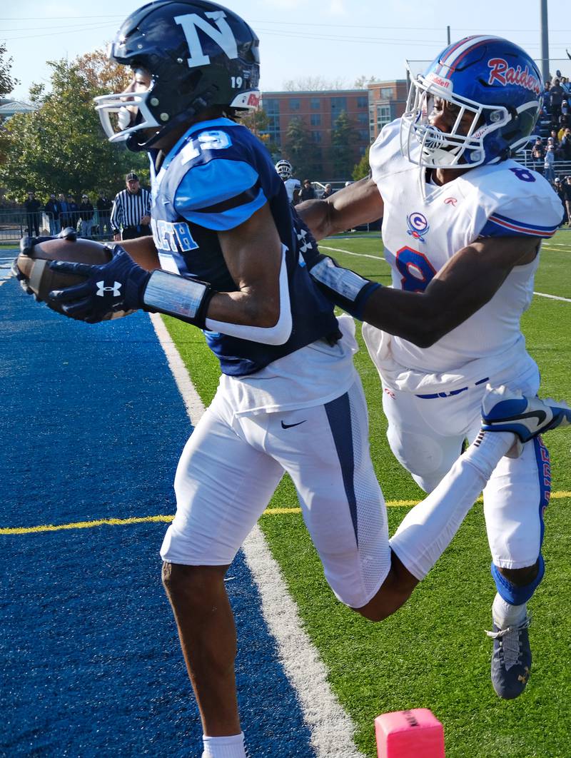 Nazareth Academy wide receiver Trenton Walker (19) scores a touchdown after making a catch as Glenbard South's Cam Williams defends during a Class 5A second round game on Nov. 4, 2023 at Nazareth Academy in LaGrange Park.