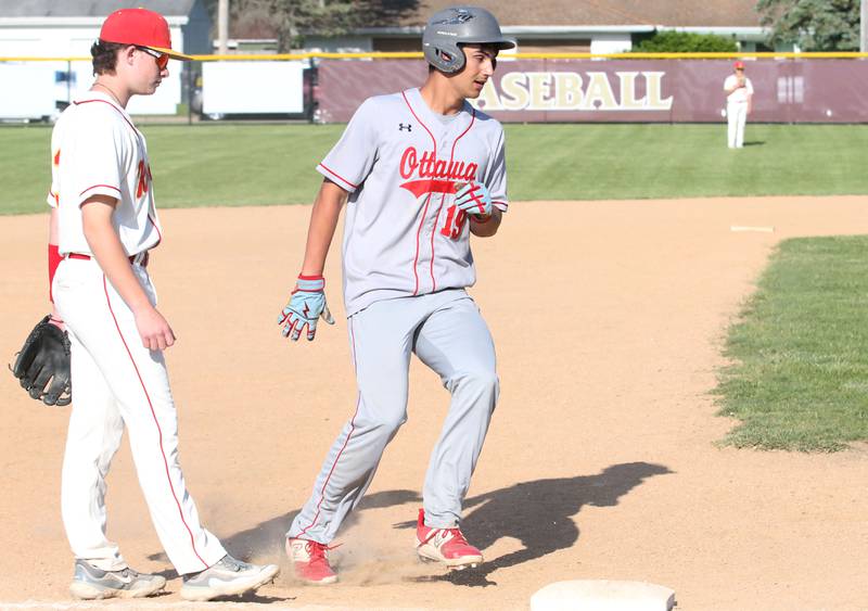 Ottawa's Payton Knoll rounds third base while Morris's Stephen Dillender watches the play during the Class 3A Regional semifinal game on Thursday, May 25, 2023 at Morris High School.