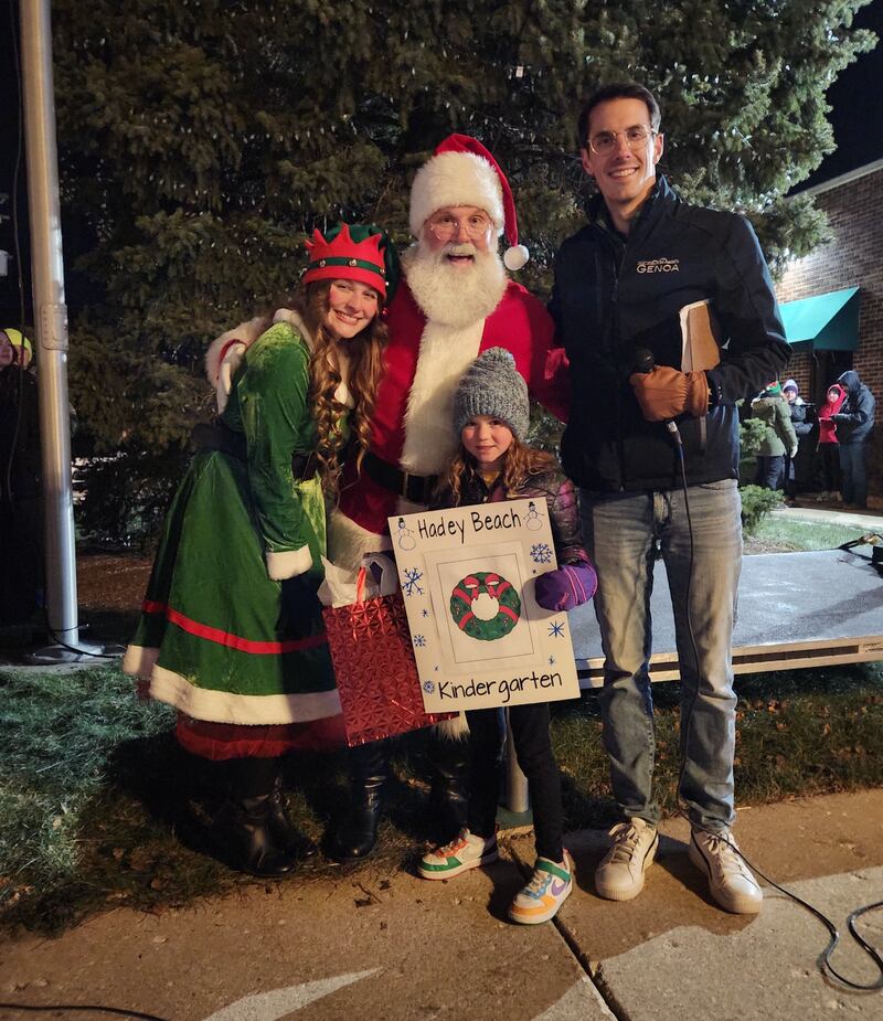 (From left) An elf from the North Pole, Santa Claus, coloring contest winner Hadey Beach and Genoa Mayor Jonathon Brust post for a photo during the annual Celebrate the Season event hosted by the Genoa Area Chamber of Commerce on Dec. 6, 2024, in downtown Genoa.