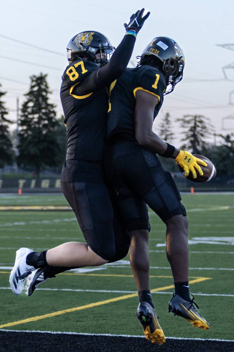 Joliet West's Sean Hogan and Jordan Bennett celebrate after Bennett scores a touchdown during a varsity football home game against Plainfield South on Sept. 12, 2025.