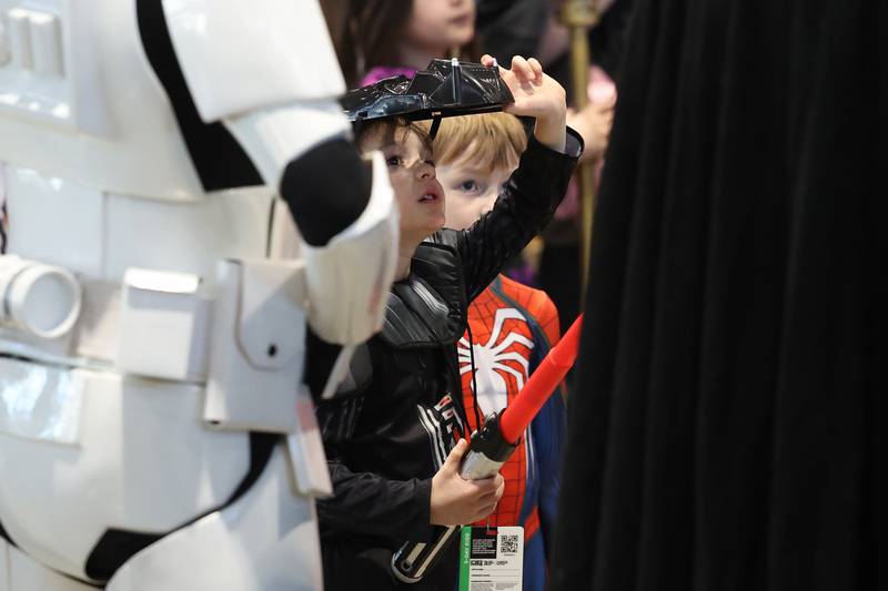 A Star Wars fan dressed as Darth Vader watches a presentation by the 501st Legion, an international costume organization, at C2E2 Chicago Comic & Entertainment Expo on Sunday, April 2, 2023 at McCormick Place in Chicago.