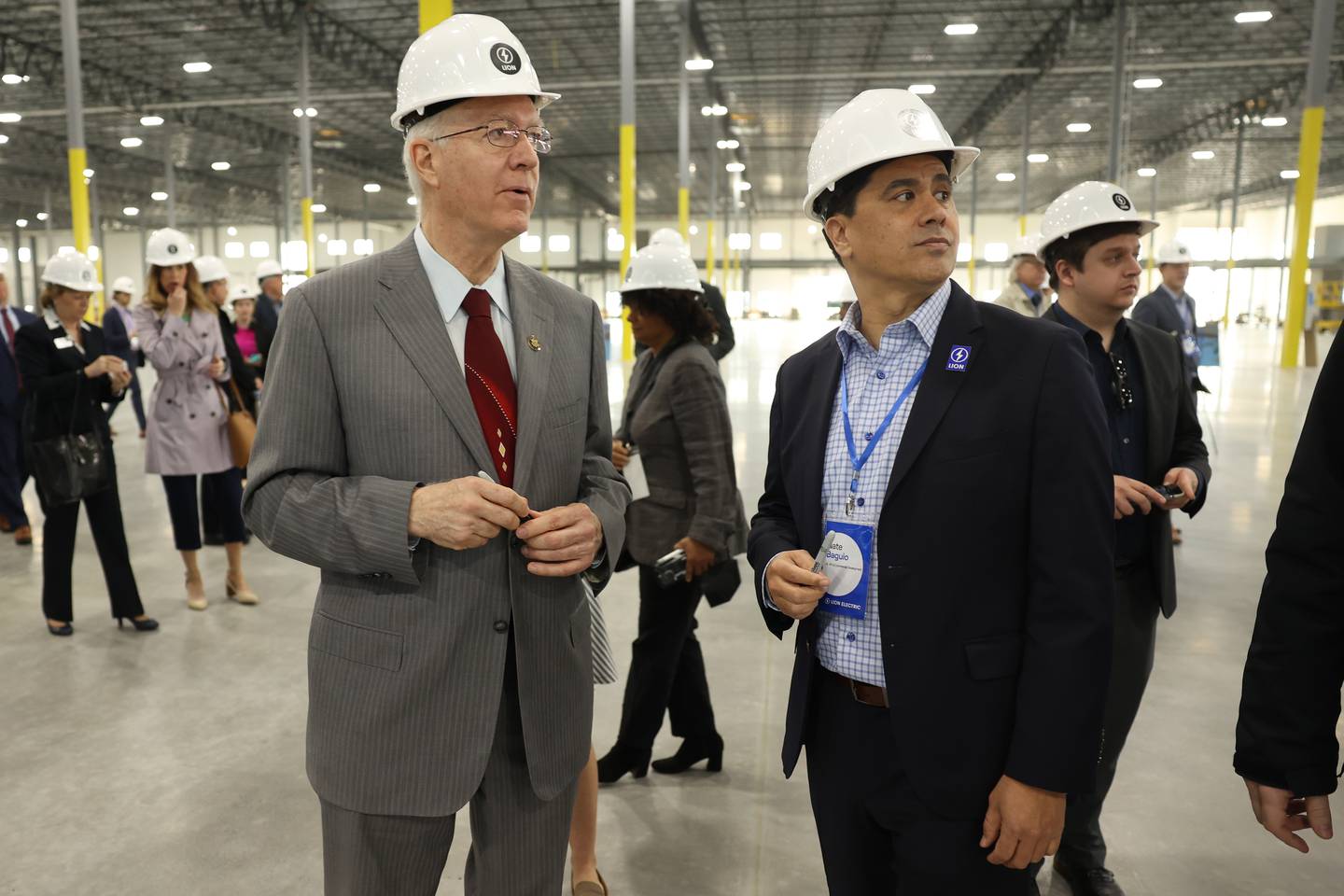 Congressman Bill Foster, left, speaks with Nate Baguio, Senior Vice President of Commercial Development for Lion Electric, during a press conference and interactive tour of the Lion Electric vehicle manufacturing facility. Monday, Mar. 21, 2022, in Joliet.