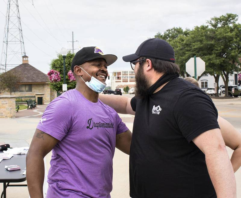 Rashaad Lane of Sterling (left), a member of the Diversity Committee of the Sauk Valley, hugs Jesse Noyes of Dixon following a discussion about equality during Friday's Juneteenth celebration on the Dixon Riverfront. The Diversity Committee of the Sauk Valley hosted two ice cream socials, one in Dixon and the other at the YWCA in Sterling, to commemorate  June 19, 1865, the day slaves in Texas learned, 2 years after the fact, that slavey had been abolished in the United States.