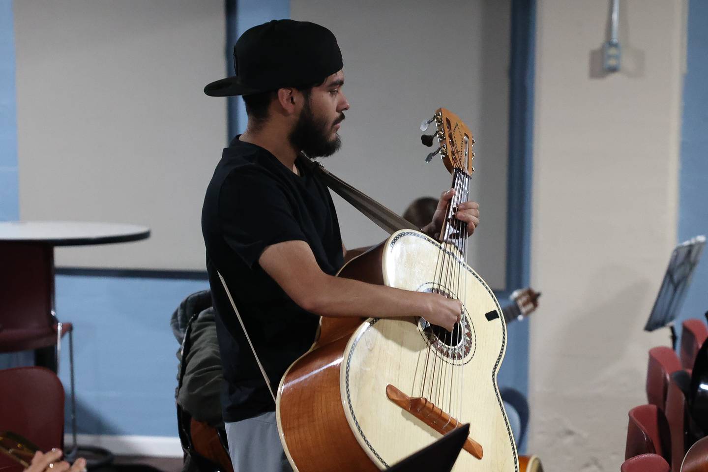 Eric Smith practices with Mariachi de Joliet, a community Mariachi band, for an upcoming fundraiser performance at the Rialto Square Theatre in Joliet.