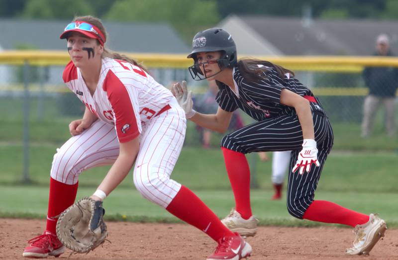 Huntley’s Katie Mitchell, right, dashes off of first base as Barrington’s Ainsley Muno plays first base during the Class 4A Huntley Sectional championship, Saturday, June 4, 2022.