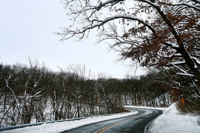 Snow sticks to the trees along the curves of Route 71 in Starved Rock State Park on Thursday, Feb. 3, 2022.