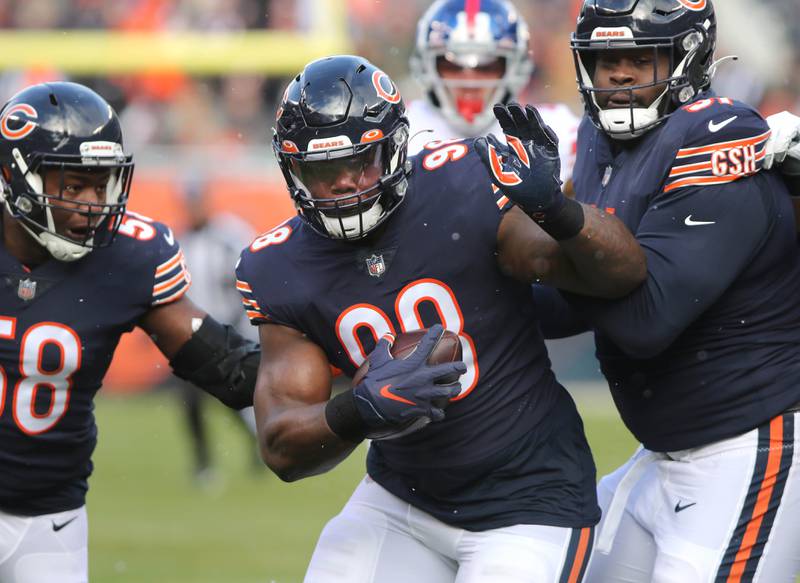 Chicago Bears defensive end Bilal Nichols carries the ball after recovering a fumble as Roquan Smith and Eddie Goldman block during their game against the New York Giants Sunday, Jan. 2, 2021, at Soldier Field in Chicago.
