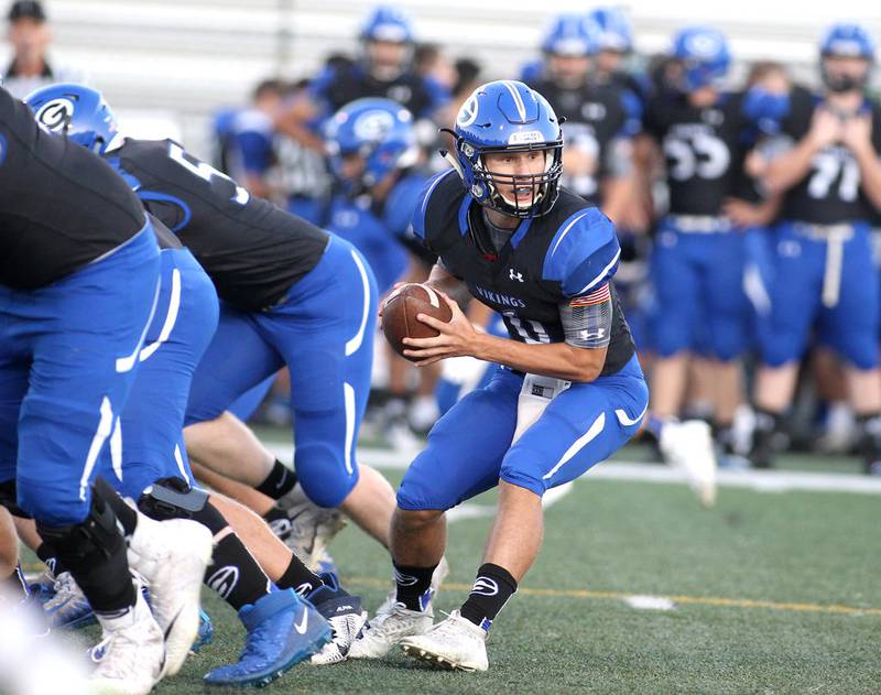 Geneva quarterback Hayden McCoy looks to hand the ball off during a scrimmage at the school on Aug. 23.