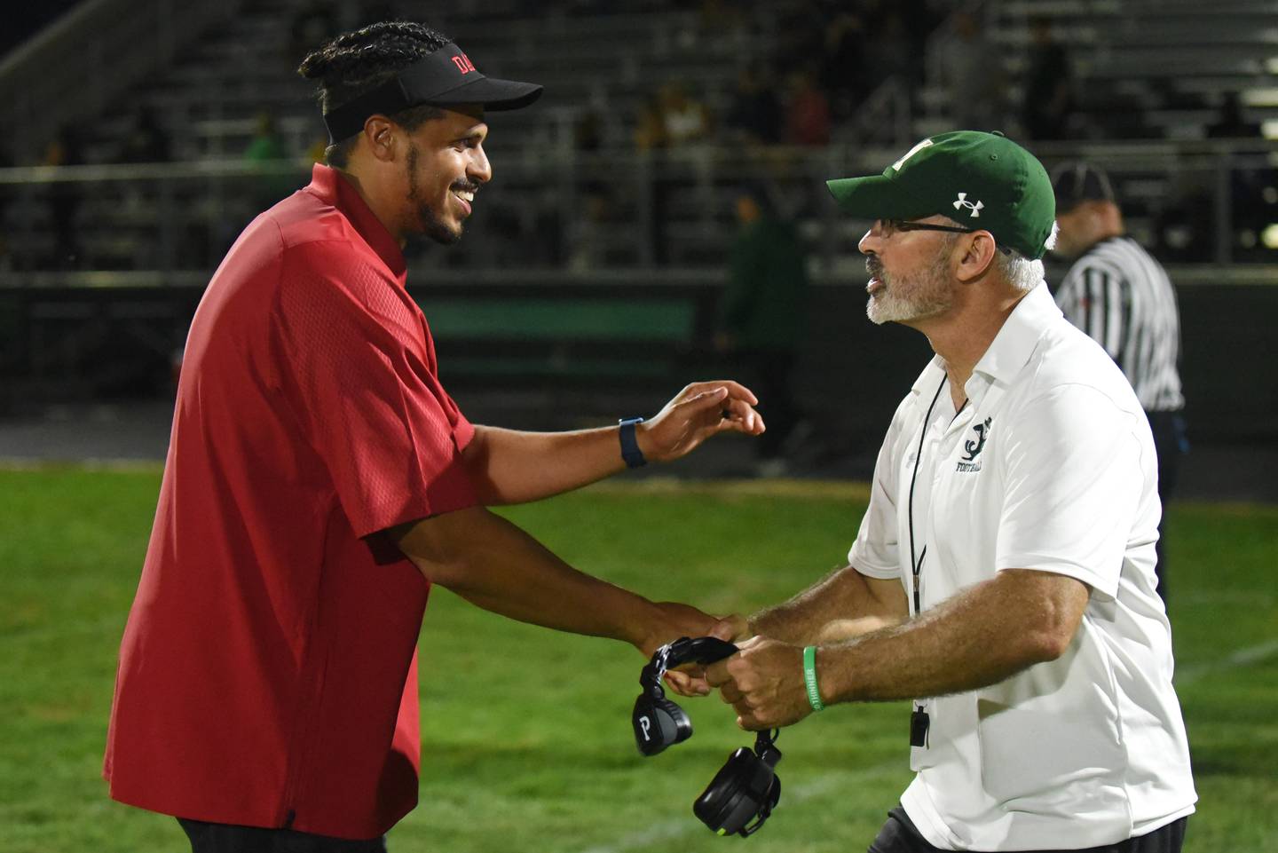 Streator football coach Jay Slone, left, and Bishop McNamara football coach Greg Youngblood shake hands following the teams' Week 0 scrimmage at McNamara's Rich Zinanni Athletic Complex Friday, Aug. 22, 2025.