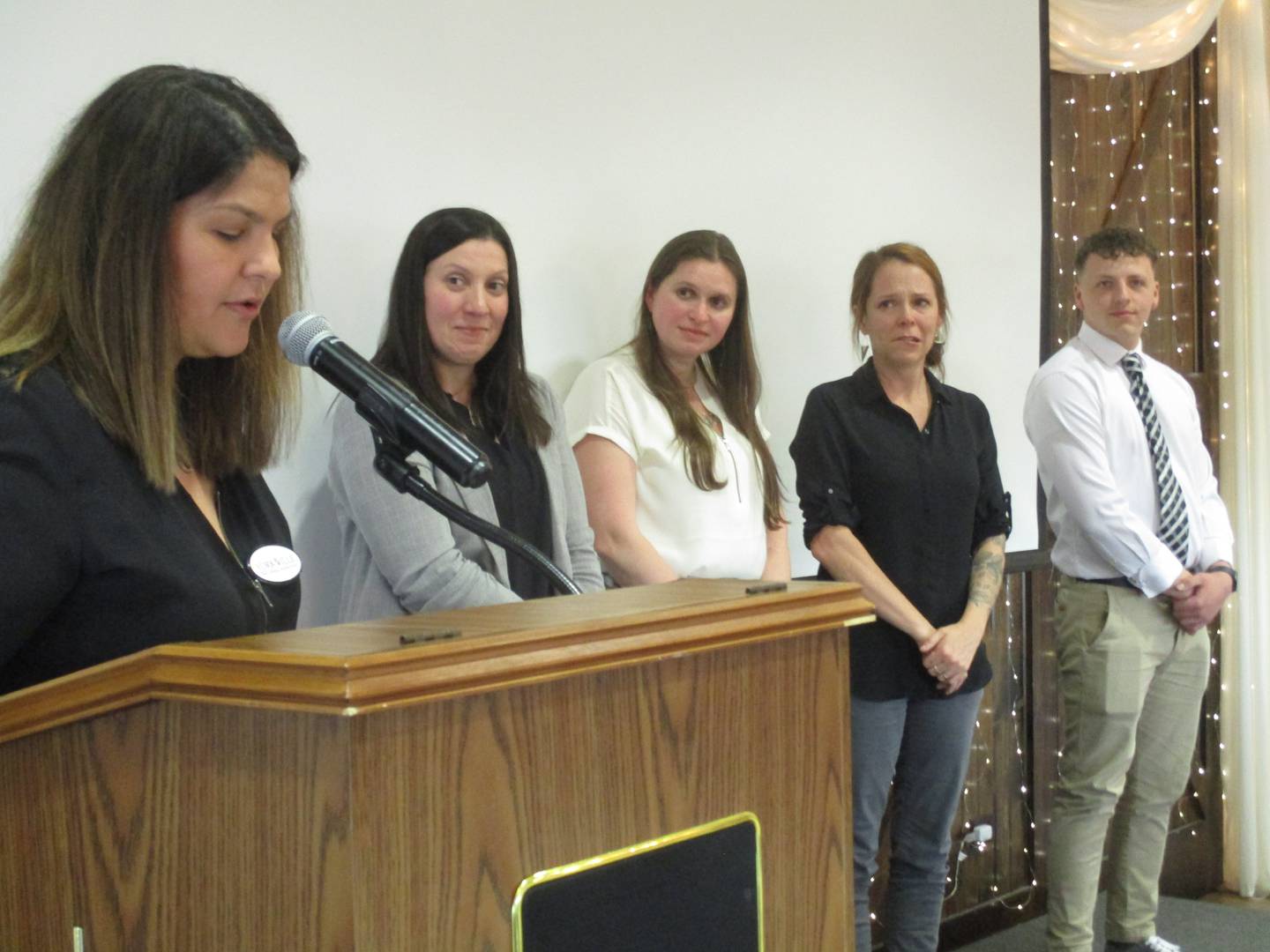 Grande Reserve Elementary School art teacher Lindsey Moss, second from right, reacts as she realizes that she is being named the Yorkville School District employee of the year by Yorkville Educational Foundation President Alicia Lingane, left, on April 5, 2023. Also seen here are Early Childhood Center Coordinator Cory Mehnert, second from left, Yorkville High School physics teacher Jessica Hellwig and Yorkville Intermediate School sixth-grade teacher Steven Beard.