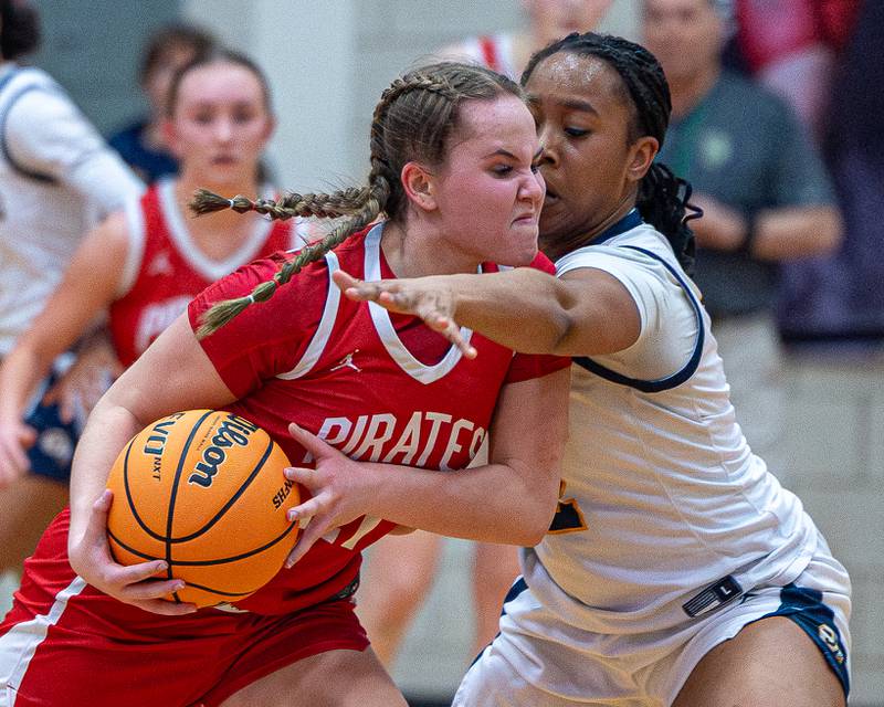 Ottawa's Hailey Thrush (21) holds ball before dribbling as Joslyn Green (22) of Sterling reaches across body of Thrus during Regional Championship game on Thursday, Feb. 19, 2026 in Sellett Gymnasium at L-P High School.