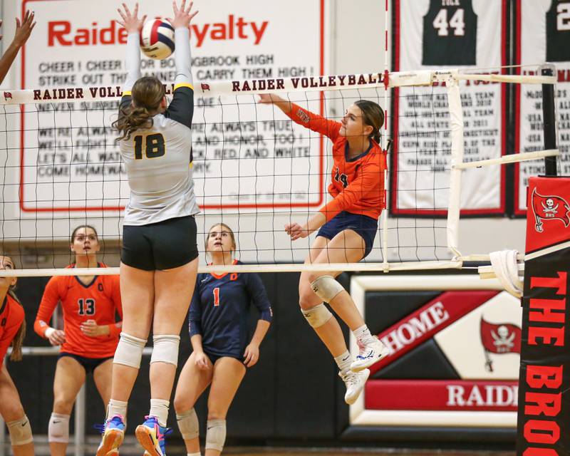 Joliet West's Penny Wagner (18) blocks a spike by Oswego's Mia Jurkovic (14) during Class 4A Bolingbrook Sectional semifinal match between Joliet West at Oswego.  Nov 5, 2024  in Bolingbrook.