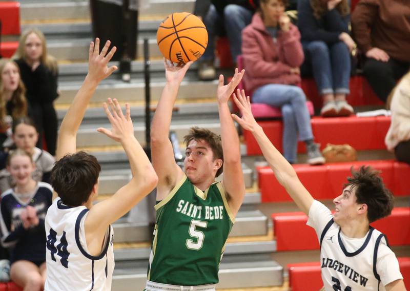 St. Bede's Halden Hueneburg eyes the hoop as Ridgeview's Landon Ludwig and Noah Hastings defend during the Route 17 Classic Tournament on Wednesday, Nov. 27, 2024 at Woodland High School.
