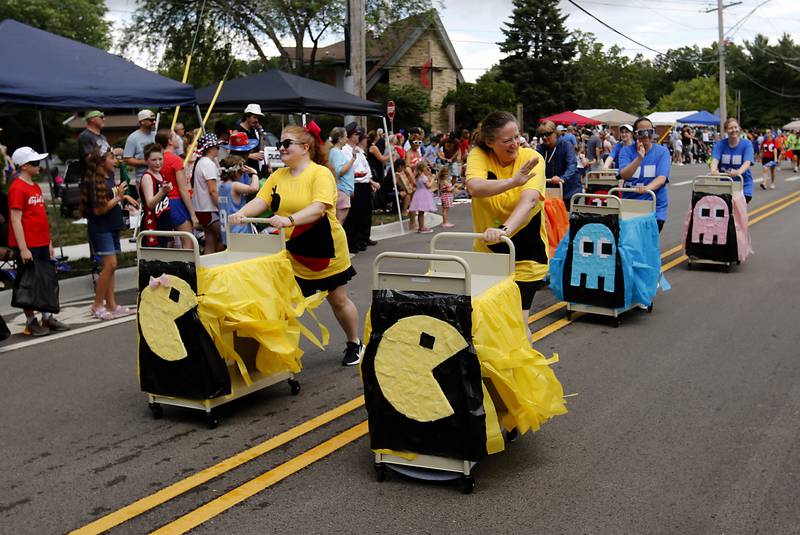 Pac-Man decorated library carts are pushed by library workers for the Crystal Lake Public Library  on Sunday, July 6, 2024, during Crystal Lake’s annual Independence Day Parade on Dole Avenue in Crystal Lake.